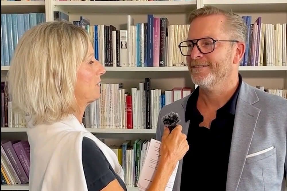 Marcus Kieffer im Interview vor einem Bücherregal.